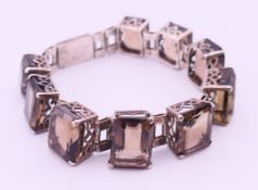A white metal and smoky quartz bracelet. 17.5 cm long, 1.5 cm high.