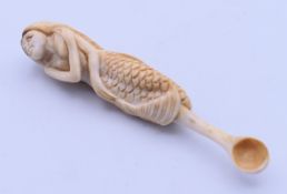 A bone snuff spoon carved as a mermaid. 8.3 cm long.