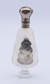 A silver-topped glass scent bottle. 11 cm high.