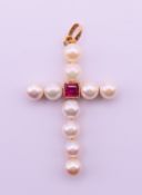 An unmarked 18 ct gold (tested) pearl and ruby cross pendant. 4 cm high, 2.
