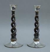 A pair of silver mounted oak candlesticks. 27 cm high.