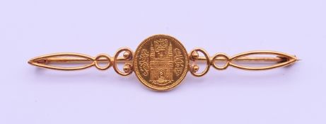 A 22 ct gold 1/8th Hyderabad Ashrafi coin, set in an unmarked 18 ct gold brooch.