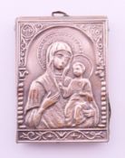 A small silver-clad religious icon pendant depicting the Virgin Mary and Child. 5.8 x 4 cm.