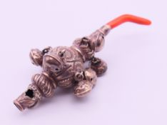 A silver and coral baby rattle and whistle. 10.5 cm high.