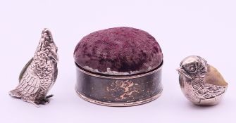 Three silver mounted pin cushions, one formed as a cockatoo (or parrot),