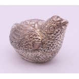A silver-plated trinket/betal nut box formed as a chick. 4 cm high.