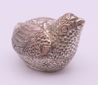 A silver-plated trinket/betal nut box formed as a chick. 4 cm high.