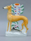 A Staffordshire pottery coursing greyhound spill vase. 23 cm high.