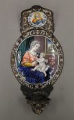 An early Limoges enamel water stoup with vignettes of God and the Virgin Mary with the Christ child,