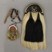 A 1908 Seaforth Highlanders' sporran and a youth's sporran. The former 39 cm long.