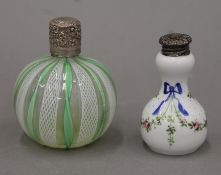 A glass scent bottle and a porcelain scent bottle, each with silver top. The former 8.5 cm high.