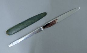 A Georg Jensen silver handled letter opener in leather sheath. 22.5 cm long.