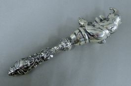 A sterling silver rattle form as Mr Punch. 14.5 cm high.