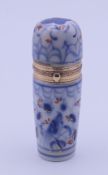 A 19th century boxed gold mounted porcelain scent bottle with stopper. 8 cm high.