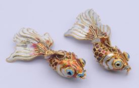 Two enamel and gilt metal articulated koi fish pendants. Approximately 9 cm long.