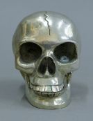A silver-plated skull. 9.5 cm high.