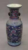 A large 19th/20th century Chinese porcelain vase decorated with dragons. 91 cm high.