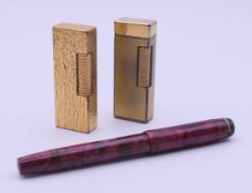 Two Dunhill lighters and a Conway Stewart 479 Universal fountain pen with 14 ct gold nib.