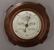 A mahogany-cased barometer by Short & Mason of London. 20 cm diameter.