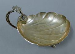 A Russian silver serving dish with scrolling floral handle and engraved initials. 16.5 cm wide. 201.