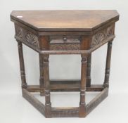 A carved oak credence table. 82.5 cm wide.