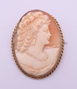 An unmarked yellow metal mounted cameo brooch. 5.3 cm high.