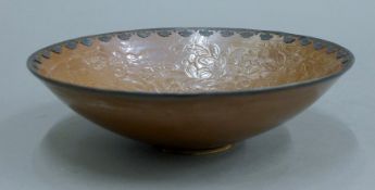 A Chinese unmarked silver-rimmed brown-glazed pottery bowl. 21 cm diameter.