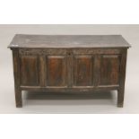 An 18th century oak four-panelled coffer. 138 cm long.