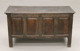 An 18th century oak four-panelled coffer. 138 cm long.