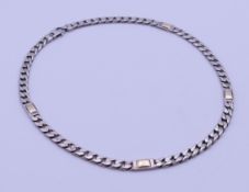 A silver curb link necklace interspersed with gold toned links. 40 cm long. 36.7 grammes.