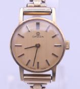 An Omega 9 ct gold ladies bracelet wristwatch, boxed. 2 cm diameter including crown. 14.