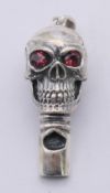 A silver skull whistle pendant. 4 cm high.