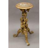 A 19th century gilt gesso stand decorated with Bacchic putti. 80 cm high.