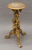 A 19th century gilt gesso stand decorated with Bacchic putti. 80 cm high.