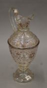 A 19th century Venetian glass ewer with clear glass body with tubular gilt decoration. 33.5 cm high.