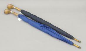 Two Creed umbrellas with wooden golfclub handles by Swaine Adeney Brigg. Each 96 cm long.