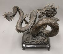 A 20th century bronze sculpture of a Chinese five-clawed dragon. 70 cm wide.