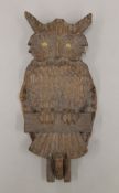 A carved wooden owl wall hanging. 30 cm high.