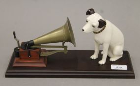 A limited edition Royal Doulton model of HMV's Nipper seated beside a gramophone. 31.5 cm long.