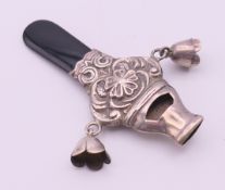 A silver baby rattle and whistle. 8 cm high.