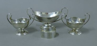 A silver napkin ring and three silver bonbon dishes. The largest 14 cm wide. 172.3 grammes.