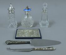 A quantity of silver-mounted items, including scent bottles, a cake knife, a telephone number book,