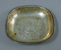 A silver dish commemorating the centenary in 1966 of Nestle. 13 cm wide. 108.4 grammes.