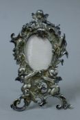 An unmarked Continental silver strut photograph frame decorated with cherubs. 15 cm high. 129.