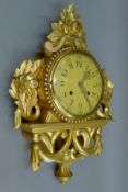 A giltwood cartel clock. 50 cm high.