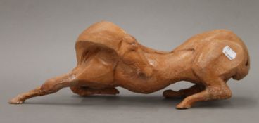 A terracotta model of a horse indistinctly signed. 45 cm long.