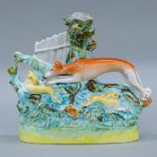 A Staffordshire pottery coursing greyhound spill vase. 19.5 cm high.