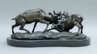 A bronze group of fighting stags mounted on a marble plinth base. 42 cm long.