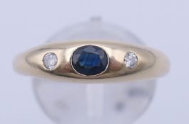 A 9 ct gold, diamond and sapphire gypsy-set ring. Ring size R/T. 2.2 grammes total weight.