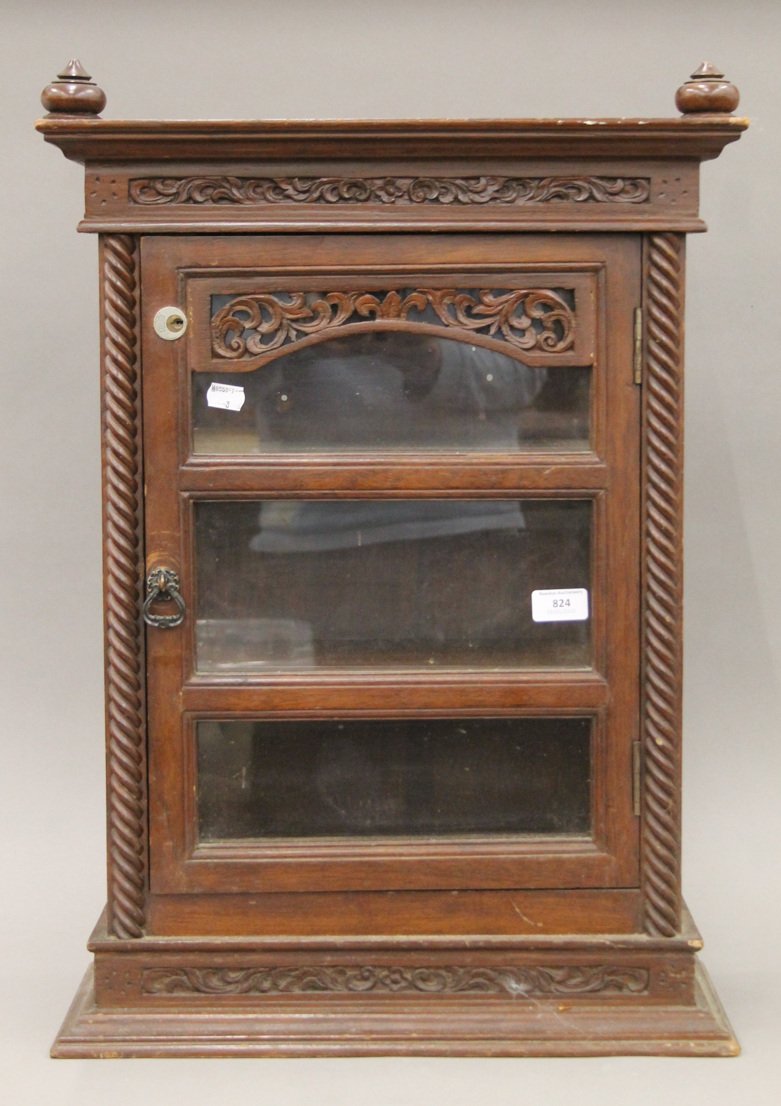 An Eastern carved hardwood glazed display cabinet. 68 cm high.